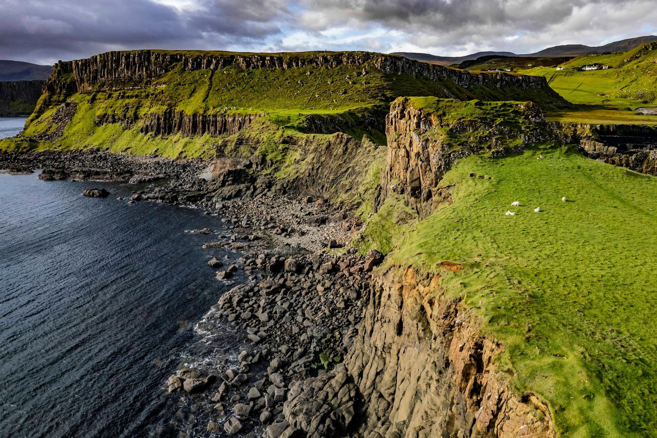 Green sea cliffs and a rocky shore on the Isle of Skye, Scotland