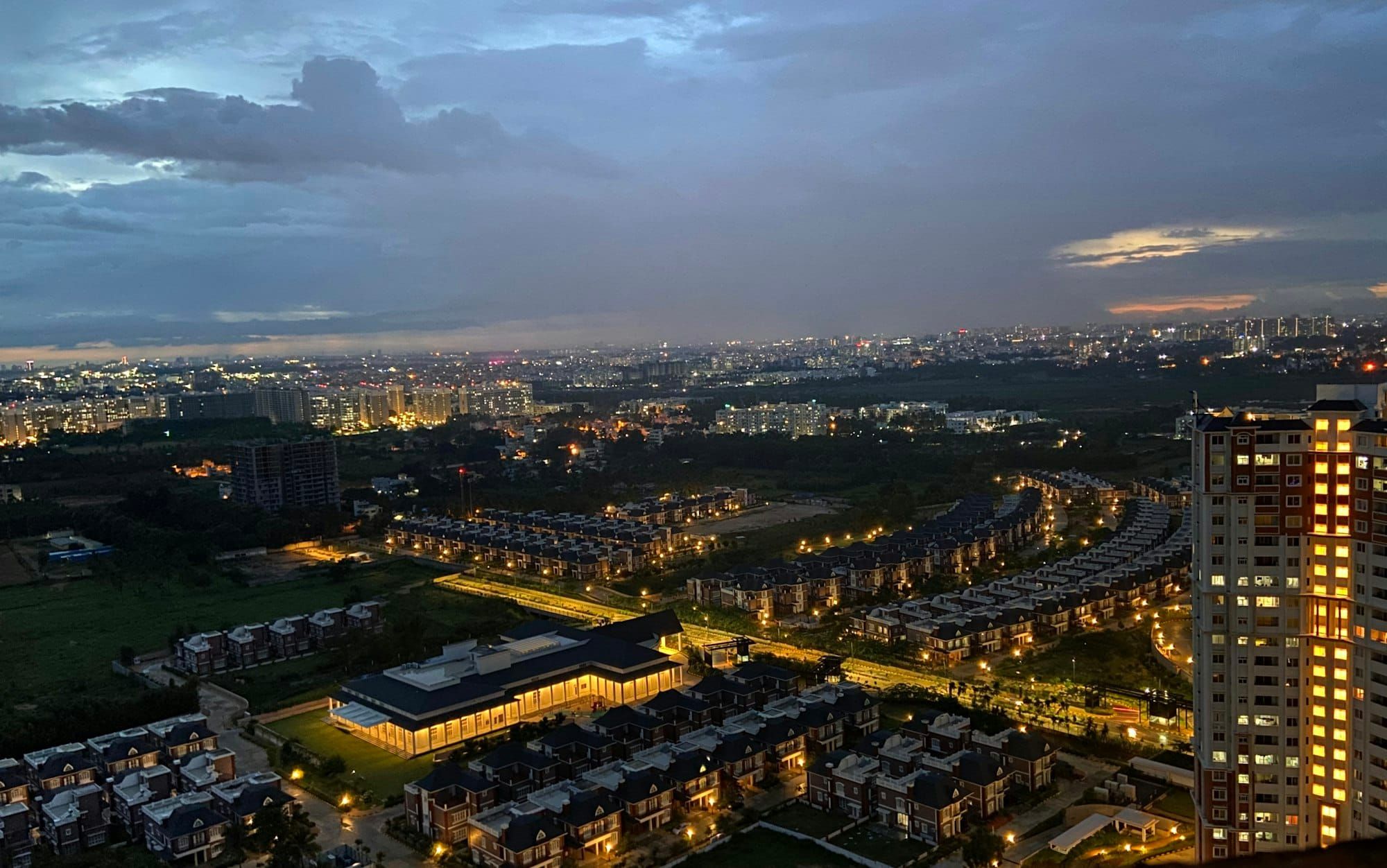 Bengaluru, India, lit up at dusk under a cloudy sky