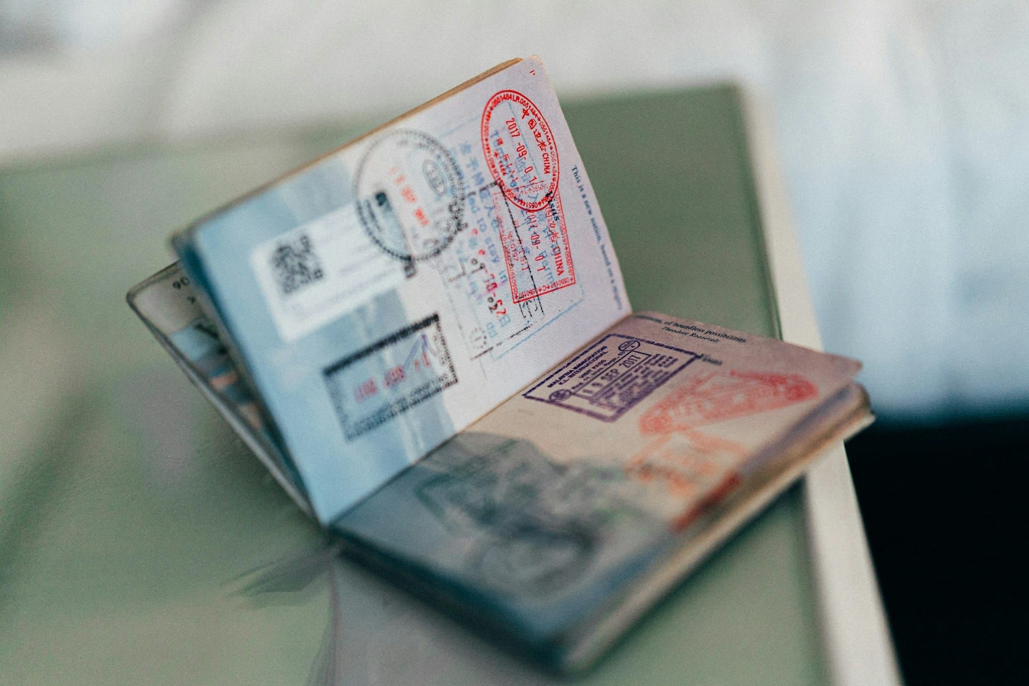 An open passport with entry stamps on its pages