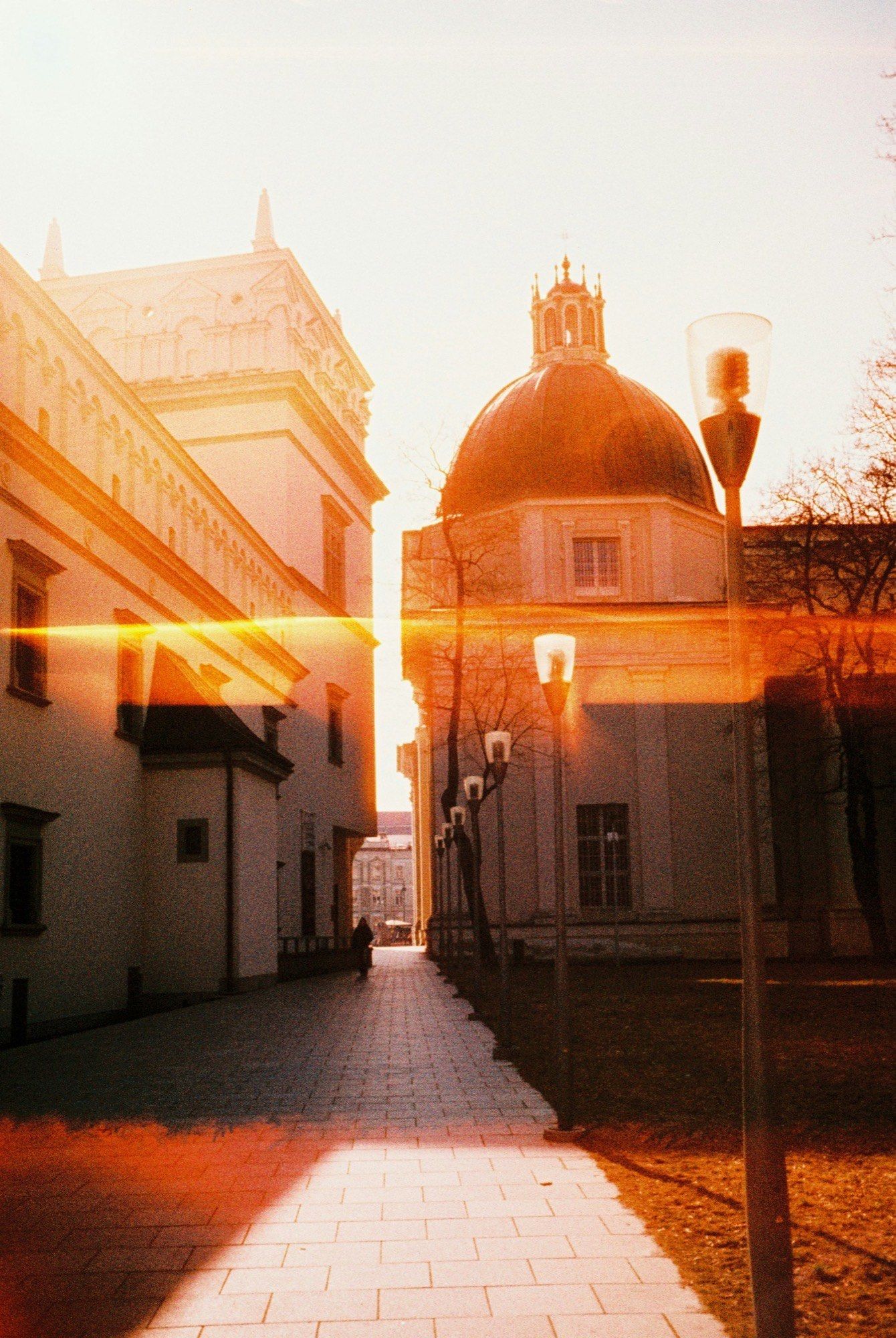Golden-hour sunlight in an old-town street in Vilnius, Lithuania
