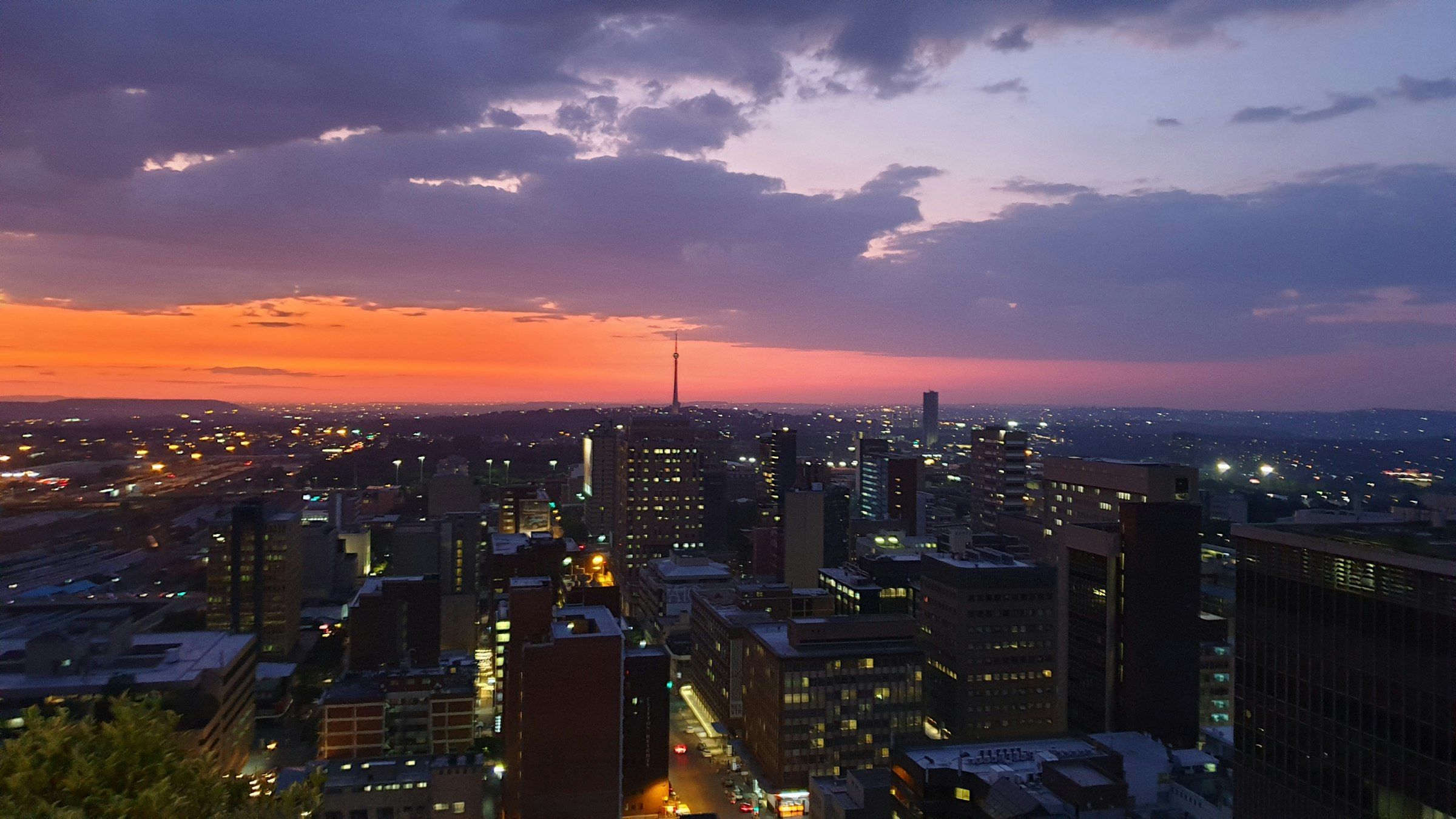 Johannesburg city centre at dusk, seen from Braamfontein, with the Hillbrow Tower on the horizon