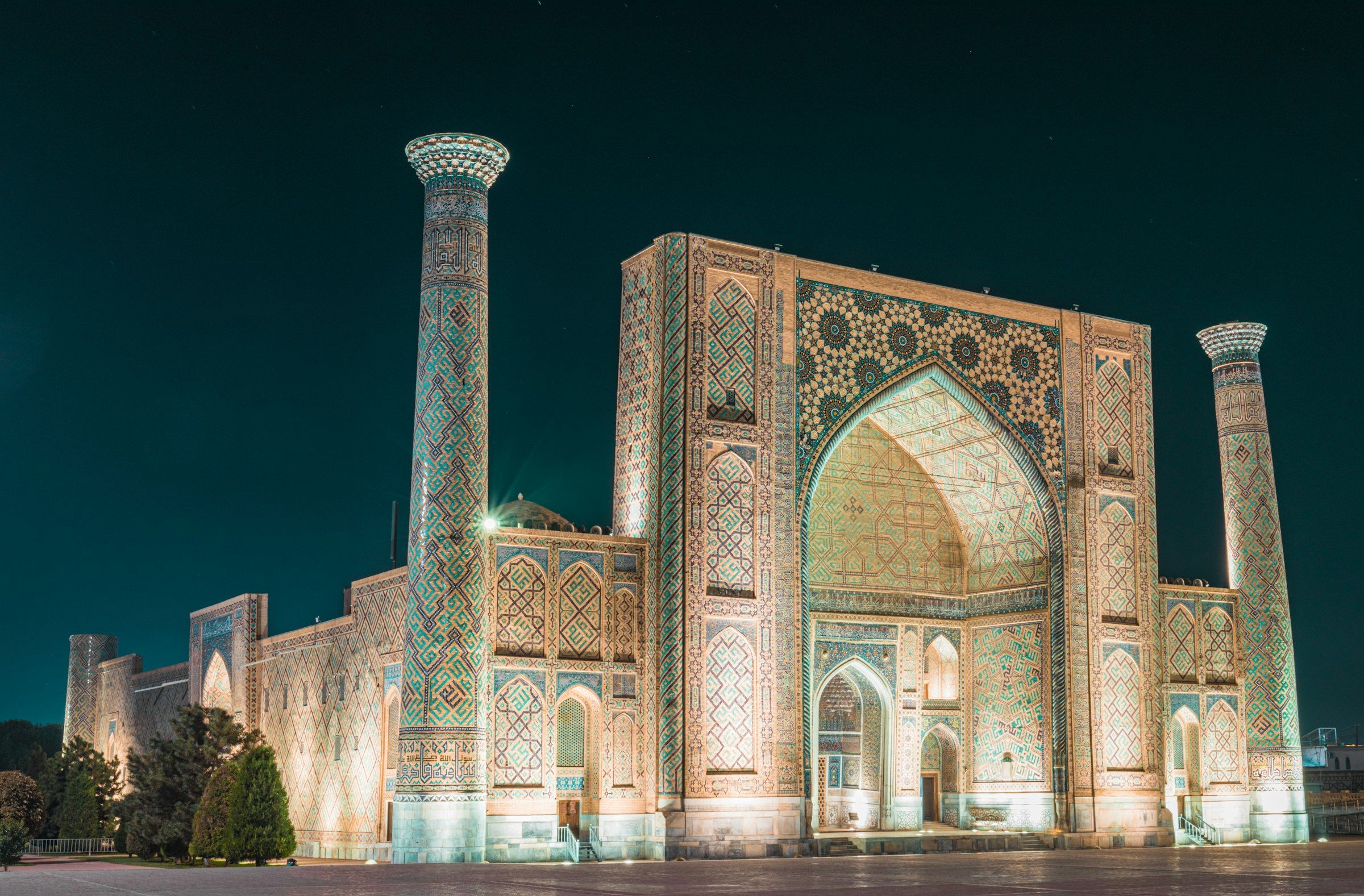 The Ulugh Beg Madrasah on Registan Square in Samarkand, Uzbekistan, lit up at night