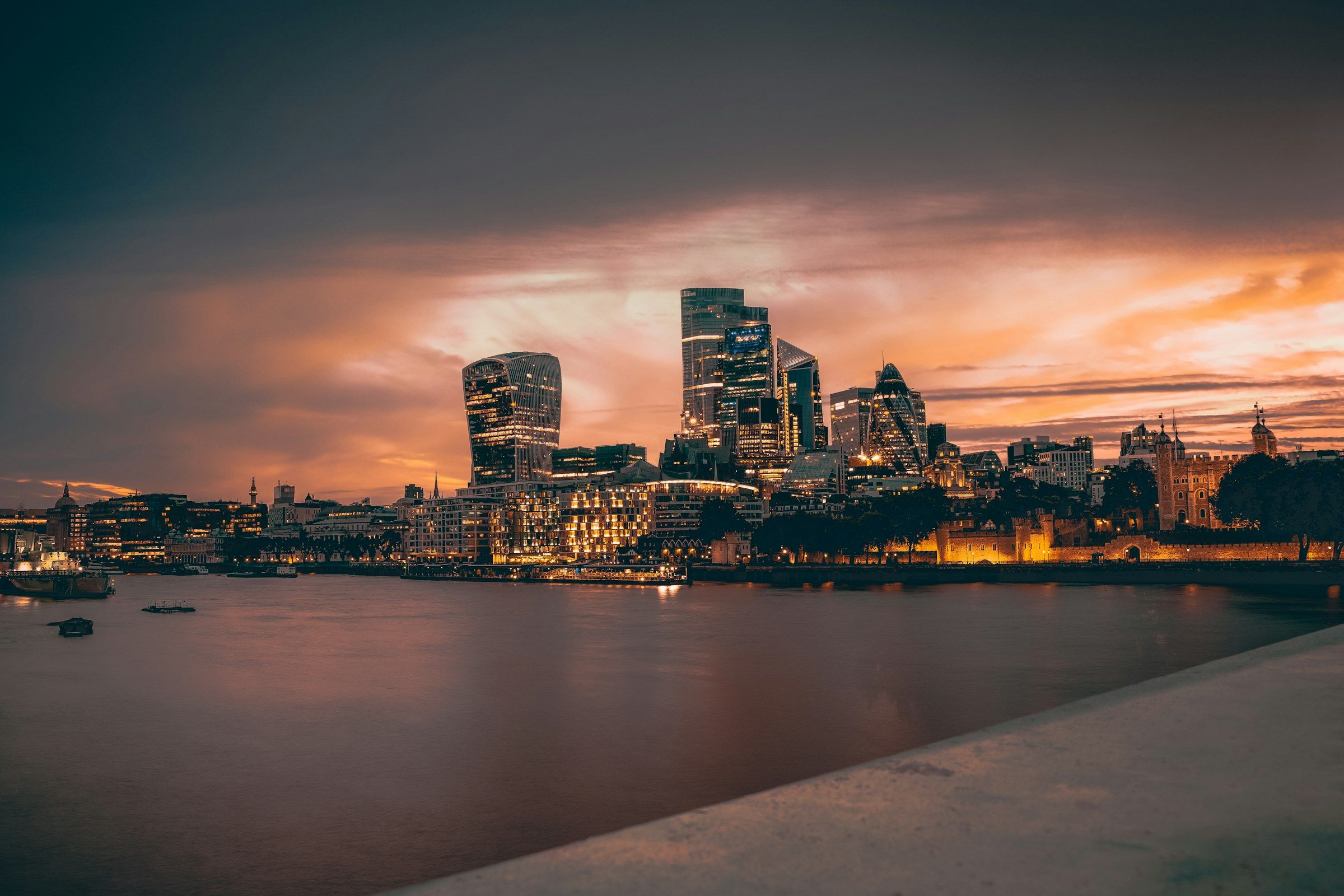 The City of London skyline across the River Thames at dusk